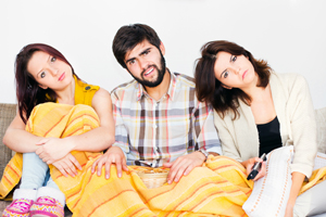 Group of friends on couch, looking confused